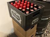 many bottles of beer in a box on the floor