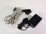 a close up of a charger and a cord on a white surface