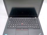 the laptop is open on a white surface with a black keyboard