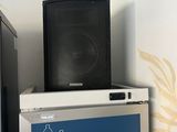 a refrigerator with a speaker on top of it in a room