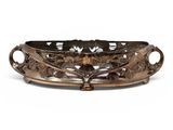 a large bronze tray with a flower design on the bottom