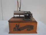 an old type of sewing machine sitting on top of a wooden box
