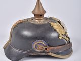 a helmet that has a gold decoration on it