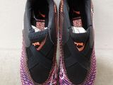 a pair of black and pink sneakers with orange accents