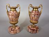 pair of antique vases on marble bases on a gray background