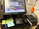 a desktop computer sitting on a desk with a calculator and telephone