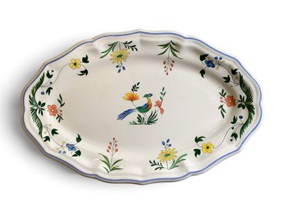 un grand plat ovale orné d'un oiseau et de fleurs