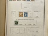 an open book with a bunch of stamps on it sitting on a table