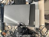a laptop and other electronics on a desk with a keyboard and mouse