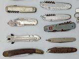 many different types of swiss army knives on the table