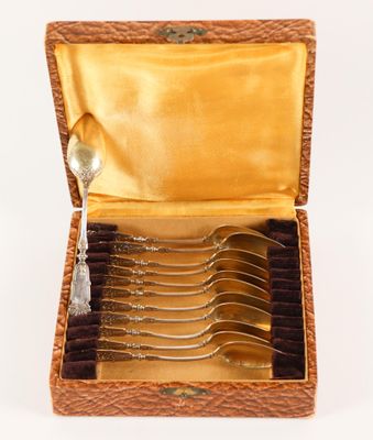 six forks in a box with a spoon in it