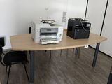 a desk with a printer and a printer on it