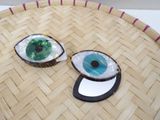 two pieces of food with eyes on them on a tray