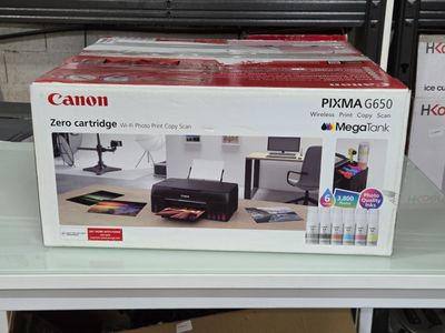une boîte contenant une imprimante Canon Pixma 6500 posée sur une table