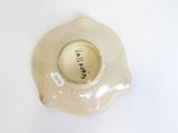 a white bowl with a label on it on a table