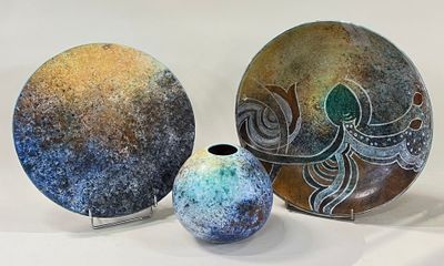 three pieces of art that are sitting on a table
