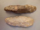 two pieces of stone on a table next to each other
