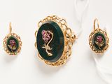 two pieces of jewelry including a ring, earrings, and a pendant