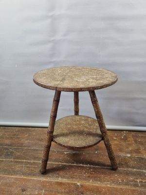 a small wooden table with two shelves on top of it