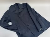 a black jacket sitting on top of a white surface