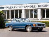 a blue car parked in front of a building