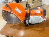 an orange and black circular saw on a wooden table