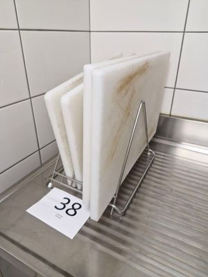 a stack of cutting boards sitting on a metal counter
