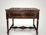 an old wooden table with a drawer on top of it