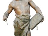 a statue of a man with a newspaper in his hand