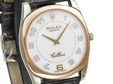a close up of a wrist watch with a white dial