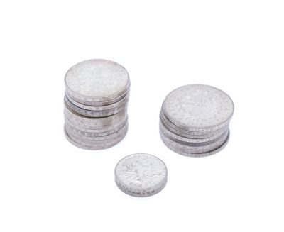 a lot of coins sitting on top of each other on a white surface