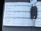 a car key sitting on top of a car ' s driver ' s license