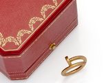 a red box with a gold ring inside of it
