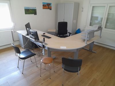 a desk with a chair and a computer on it