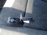a car key that is attached to the seat belt of a car