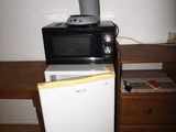 a microwave sitting on top of a refrigerator in a room