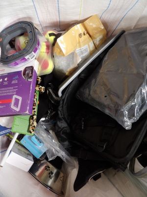 a black bag full of items sitting on a bed