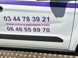 a white van with a purple stripe parked on the side of the road