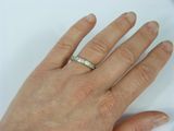 a woman ' s hand with a diamond ring on it