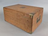 a small wooden box with a metal latch on it