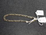 two tags attached to a chain on a black surface