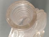 a clear glass vase with a bird design on it