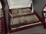 a lot of silverware in a case on a table