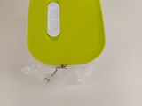 a green bowl with a white lid on a table