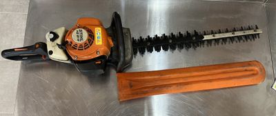 an image of a chainsaw and a tool on a metal surface