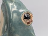 a ceramic bird that is sitting on a table