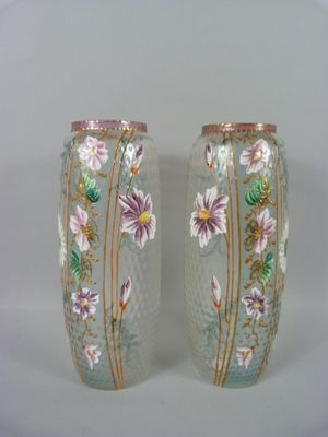 deux vases avec des fleurs peintes sur une surface blanche