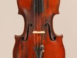 an old violin with a bow hanging from it ' s back