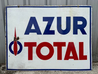 a sign that says azur total on the side of a building