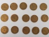 several different types of coins are arranged on a white surface